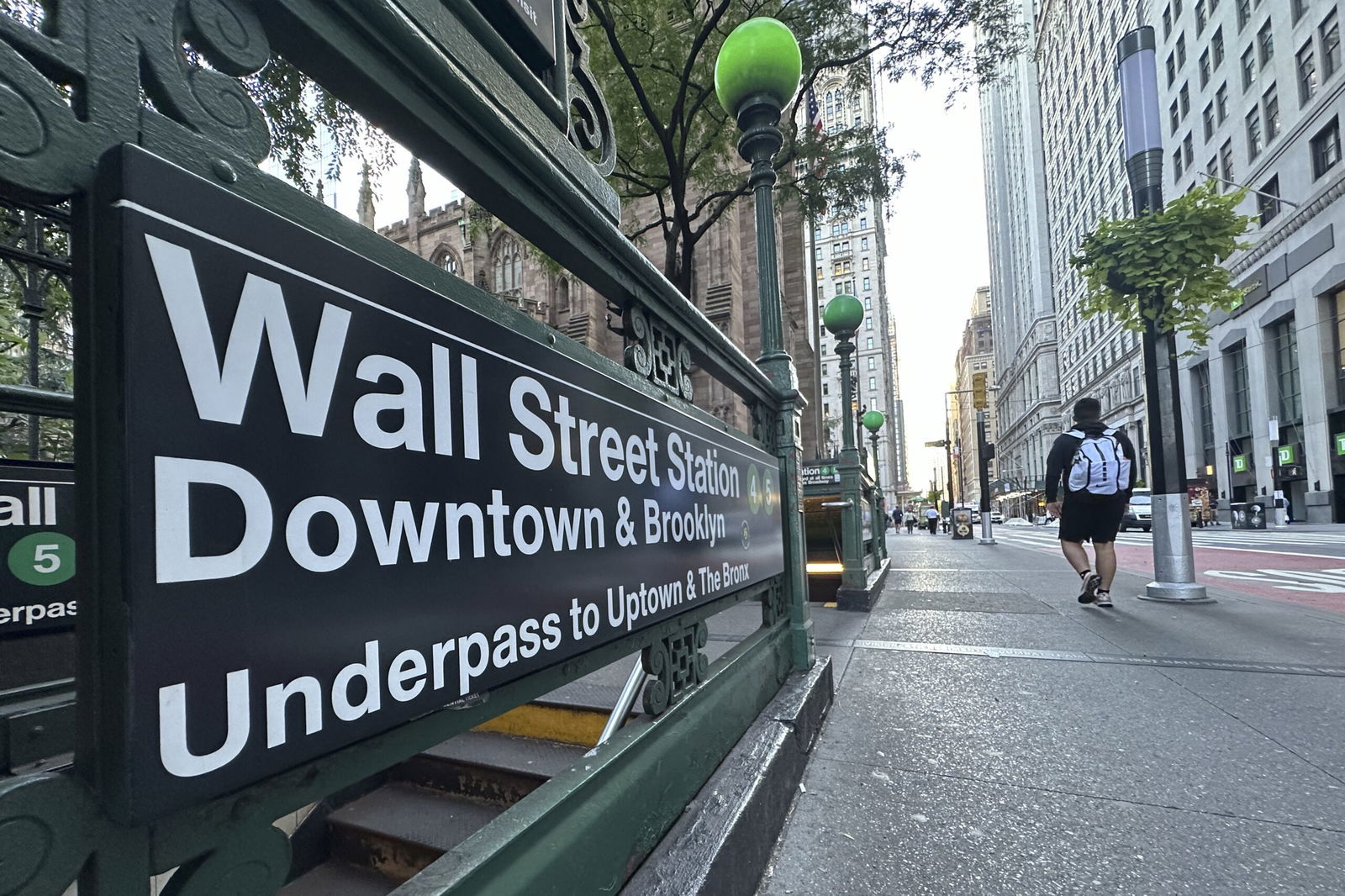 People pass the entrance for the Wall Street subway station on Sept. 2 in New York.