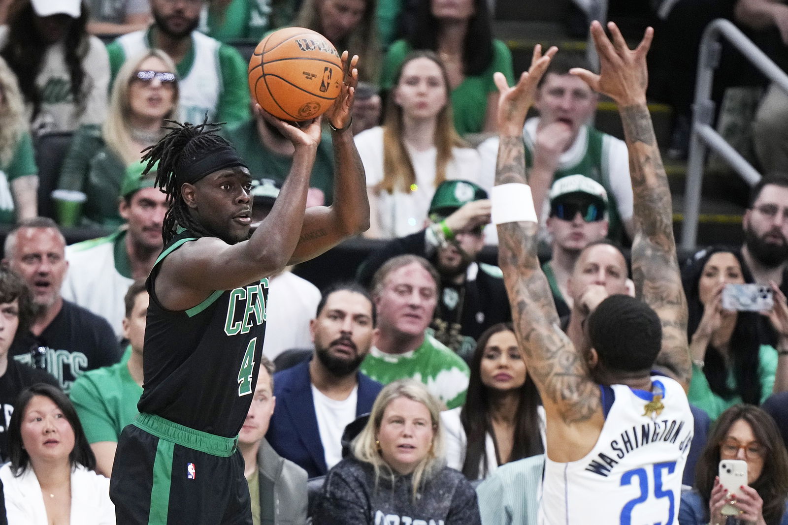 Boston Celtics guard Jrue Holiday takes a shot over Dallas Mavericks forward P.J. Washington during the first half of Game 2 of the NBA Finals on Sunday in Boston.