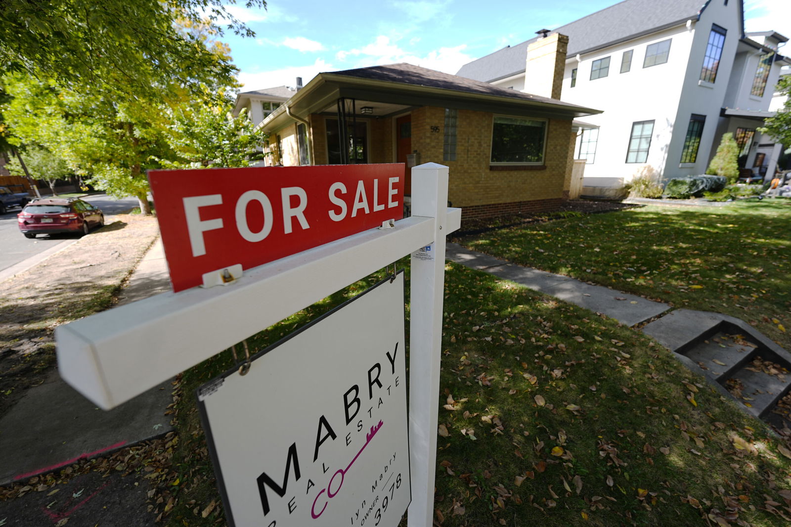 A sale sign stands outside a home on the market on Oct. 17 in the east Washington Park neighborhood of Denver.