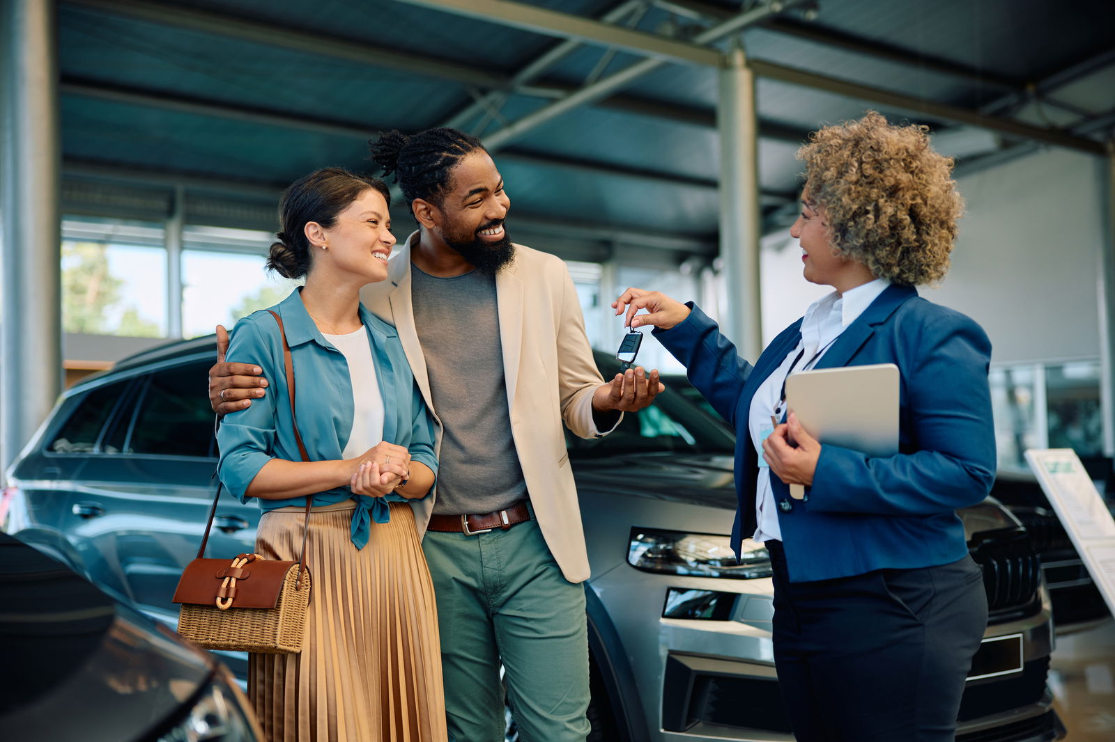 A couple receives the keys to their new car.