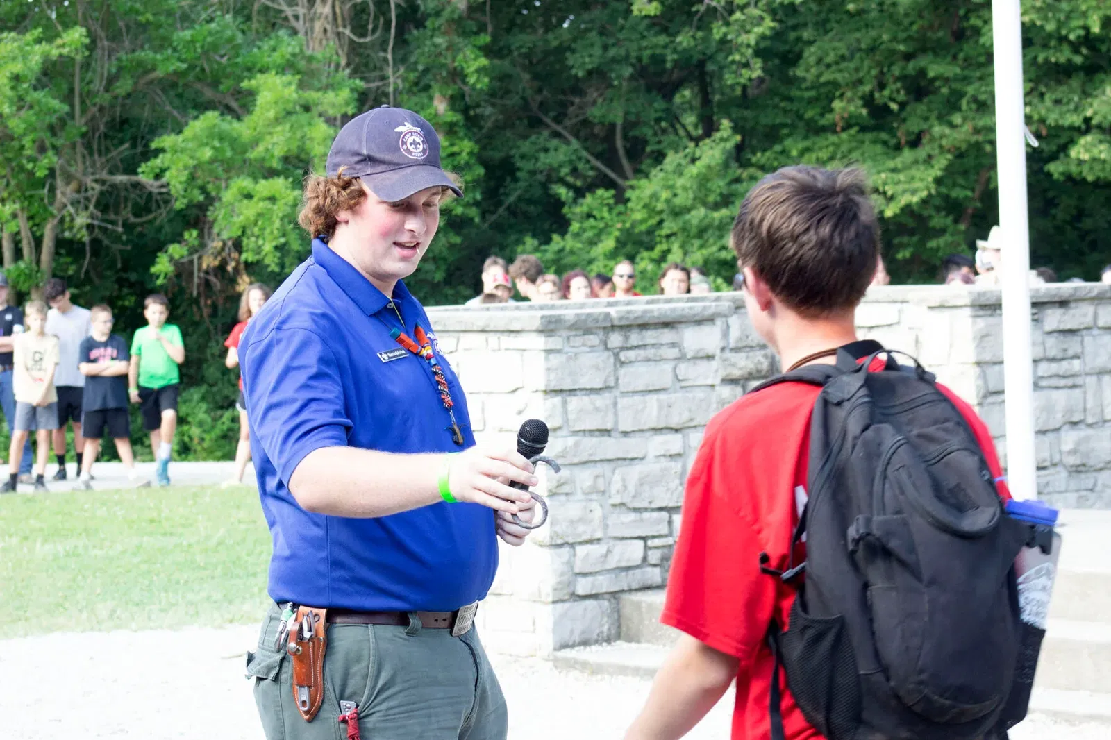 Boy Scout camp counselor Maverick McFarland helps a young scout at Camp Geiger during a previous camp.