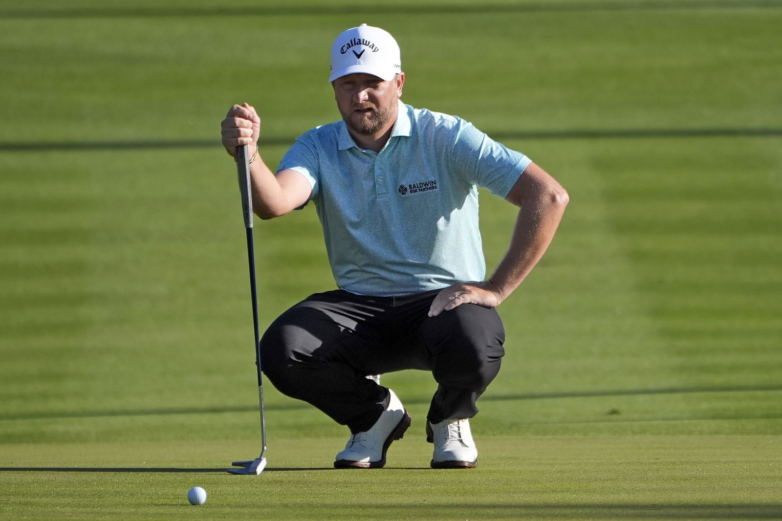 Brice Garnett checks his line on the second hole during the first round of The Players Championship golf tournament March 14 in Ponte Vedra Beach