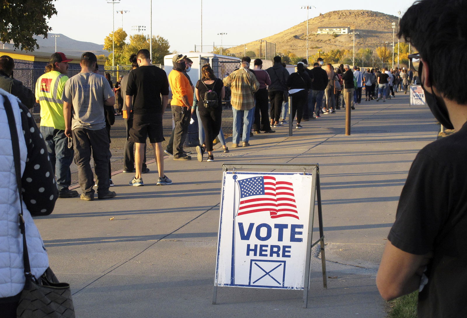 People wait to vote in-person in 2020 at Reed High School in Sparks