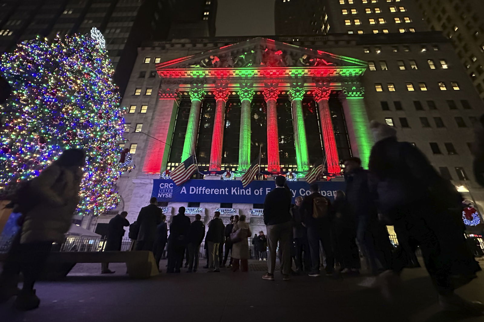 People gather in front of the New York Stock Exchange on Tuesday in New York’s Financial District.