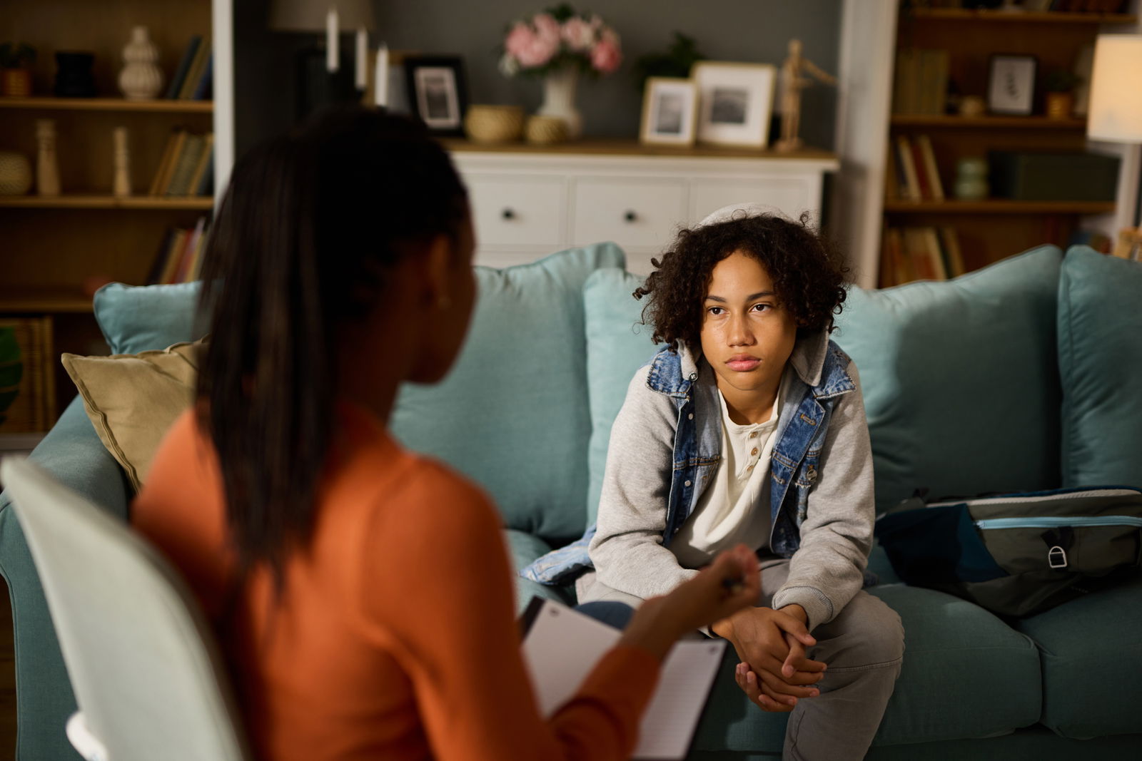 A teenage boy talks to a counselor.