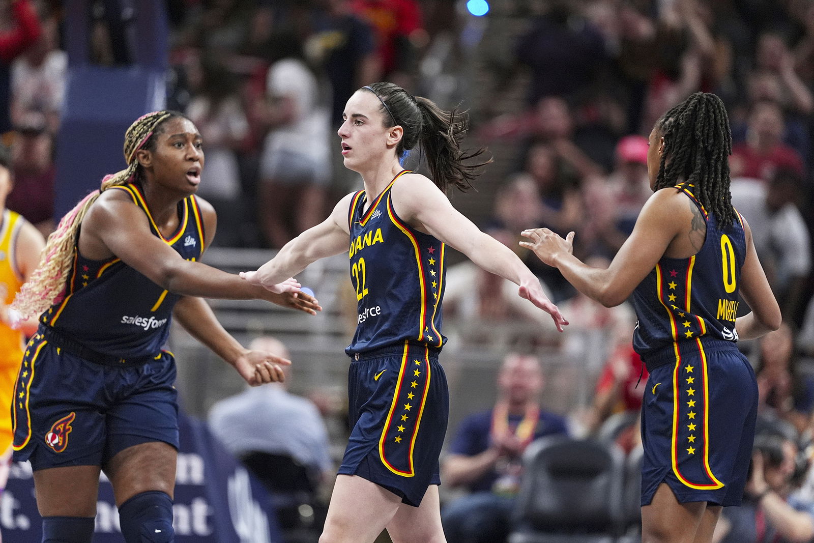 Indiana Fever guard Caitlin Clark is congratulated by Aliyah Boston and Kelsey Mitchell during the second half of the team’s game against the Los Angeles Sparks on May 28 in Indianapolis.