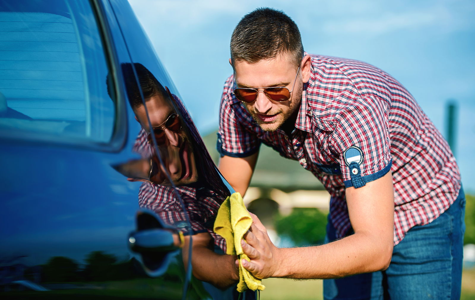 A man polishes his car.