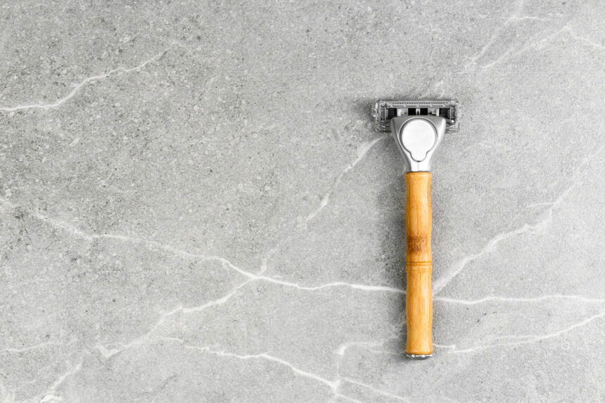 Shaving Razor with wooden handle on a grey marble