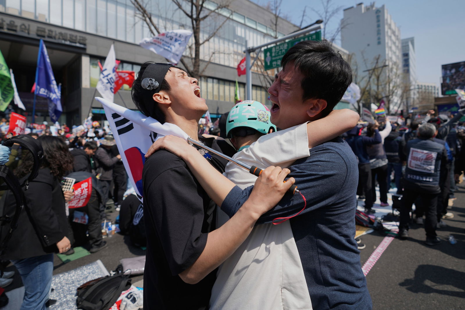 People react after hearing the news that President Yoon Suk Yeol was removed from office