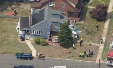 The driver of a dump truck was removed safely after slamming into a home in Gloucester County