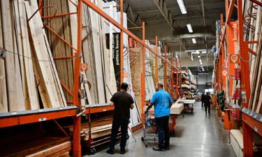 People shop for lumber from a Home Depot store in Alhambra