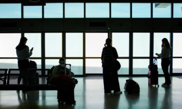A sign notifies passengers at a security checkpoint about Real ID requirements for travel at O'Hare International Airport on May 7.