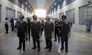 Police officers stand guard during a media tour at the Terrorism Confinement Center (CECOT) prison in Tecoluca