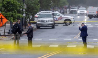 Police and Investigators work at the crime scene on May 22.