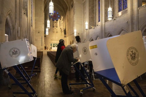 FILE - A voter casts a ballot at the Church of the Heavenly Rest in New York on Election Day