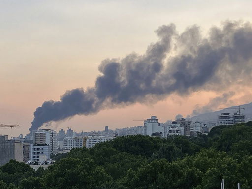 Smoke rises from the building of Iran's state-run television after an Israeli strike in Tehran