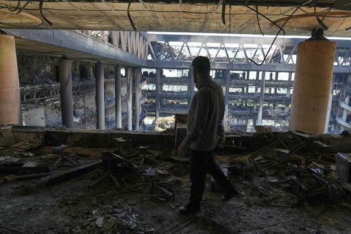 A man walks in the damaged headquarters of Islamic Republic of Iran Broadcasting