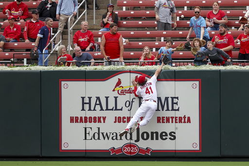St. Louis Cardinals' Alec Burleson is unable to catch a home run ball hit by Kansas City Royals' Jonathan India during the first inning in the first baseball game of a doubleheader