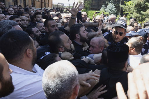 Armenian National Security Service officers clash with parishioners as they arrive to arrest Mikael Ajapahyan