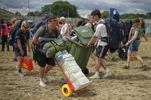 Festival goers arrive at the Glastonbury Festival in Worthy Farm