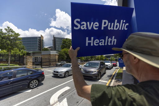 Michael Beach protests President Donald Trump's proposed cuts to health services outside the Centers for Disease Control and Prevention (CDC) headquarters in Atlanta on Tuesday