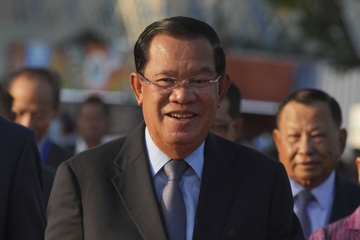 FILE - Cambodian President of the Senate Hun Sen smiles as he arrives at Victory Day to mark the 46th ouster anniversary of the Khmer Rouge regime that ruled Cambodia from 1975 to 1979