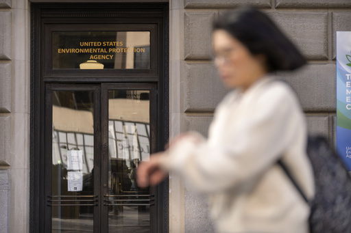 FILE - A person walks past the headquarters building of the Environmental Protection Agency