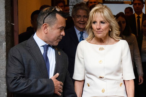 FILE - First lady Jill Biden talks with senior adviser Anthony Bernal before her speech at the Carondelet Palace in Quito
