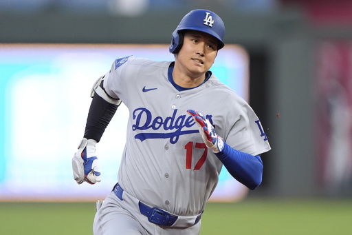 Los Angeles Dodgers' Shohei Ohtani runs to third after hitting a triple during the fifth inning of a baseball game against the Kansas City Royals