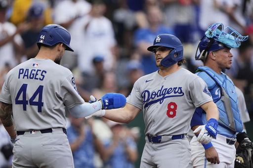 Los Angeles Dodgers' Kike Hernandez (8) celebrates with Andy Pages (44) after hitting a two-run home run during the second inning of a baseball game against the Kansas City Royals