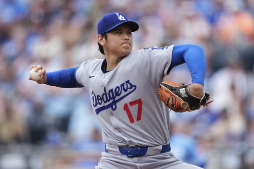 Los Angeles Dodgers starting pitcher Shohei Ohtani throws during the first inning of a baseball game against the Kansas City Royals