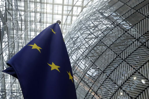 FILE - The European Union flag stands inside the atrium at the European Council building in Brussels