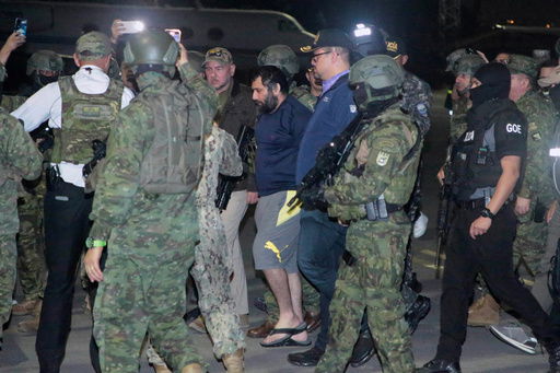 Escorted by soldiers and police officers