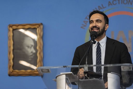 Democratic mayoral candidate Zohran Mamdani speaks next to a portrait of Martin Luther King Jr. during the National Action Network's Saturday action rally at House of Justice in Harlem