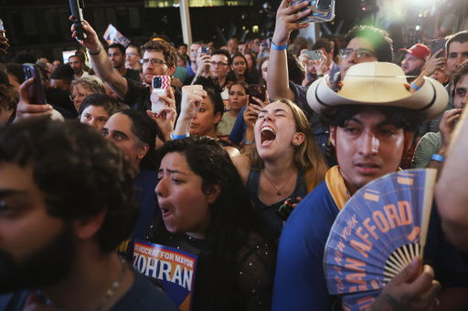 Supporters of Democratic mayoral candidate Zohran Mamdani cheer while he speaks at his primary election party