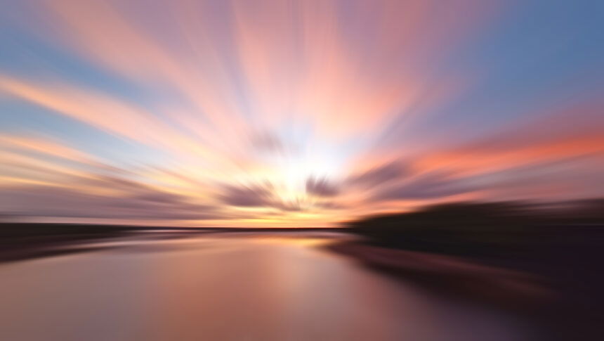 Beautiful colorful sunset over the sea. Sunset sunrise backgrounds. Sunset sky background with smooth rushing clouds and soft wave water on the beach.