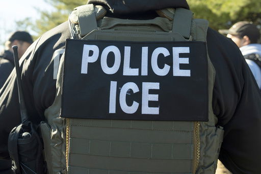 FILE - A U.S. Immigration and Customs Enforcement officer listens during a briefing