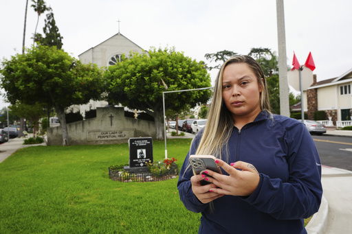 Melyssa Rivas poses for a photo at a location where she witnessed masked federal agents detaining a person earlier this month outside Our Lady of Perpetual Help Catholic Church in Downey