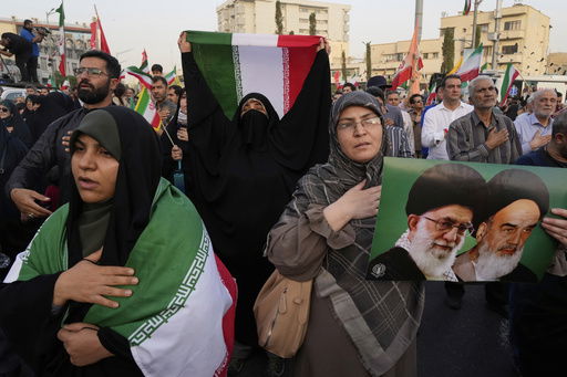 Iranian protesters hold their country's flags and a poster of Supreme Leader Ayatollah Ali Khamenei