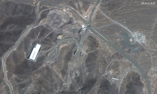 This satellite image provided by Maxar Technologies shows vehicles at Fordo enrichment facility in Iran on Thursday