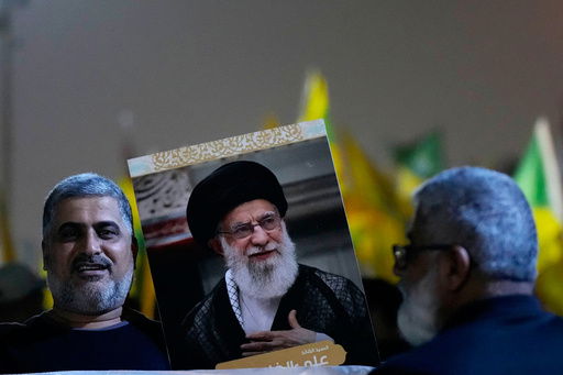 A protester holds a portrait of Iran's Supreme Leader Ayatollah Ali Khamenei during a protest against Israeli attacks on multiple cities across Iran