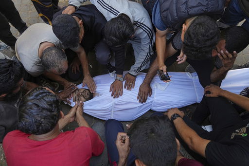 Relatives mourn over the body of Palestinian Bilal Abu Amsha