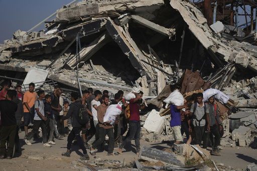 Palestinians carry humanitarian aid packages distributed by the Gaza Humanitarian Foundation operated by the U.S.-backed organization in Khan Younis