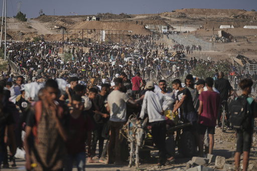 Palestinians carry humanitarian aid packages near the Gaza Humanitarian Foundation distribution center operated by the U.S.-backed organization in Khan Younis