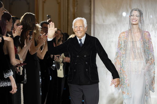 FILE - Giorgio Armani gestures at the end of the Giorgio Armani Prive Haute Couture Spring Summer 2025 collection in Paris