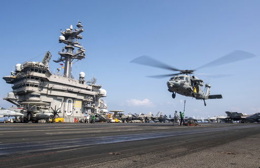 FILE - This photograph released by the U.S. Navy shows a MH-60S Sea Hawk helicopter hovering over the USS Carl Vinson aircraft carrier while operating in the Middle East April 12