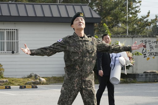 FILE - K-pop band BTS's member J-Hope reacts after being discharged from a mandatory military service outside of an army base in Wonju