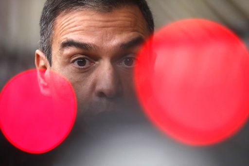 FILE- Spain's Prime Minister Pedro Sanchez speaks on camera as he arrives for an EU summit at the European Council building in Brussels