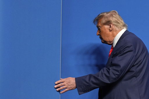 President Donald Trump leaves after a media conference at the end of the NATO summit in The Hague