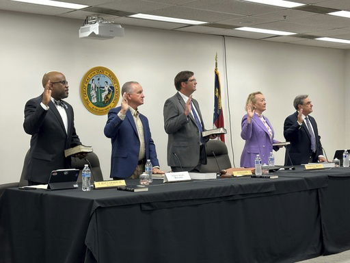 FILE - Newly appointed members of the North Carolina State Board of Elections